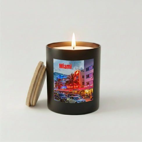Lit Miami candle with Ocean Drive neon street scene in a black jar.