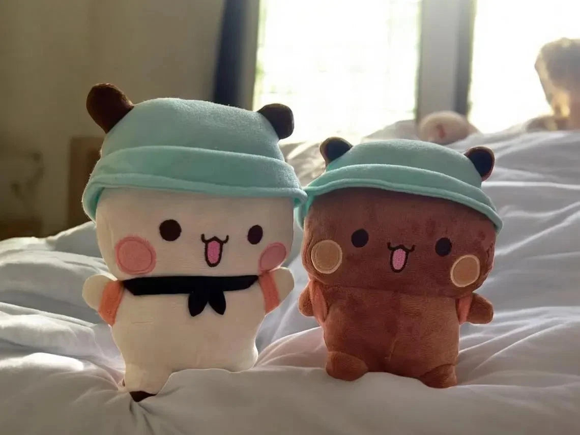 bubu dudu plush with light blue headbands on a white surface.